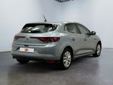 the rear end of a grey car parked in a garage