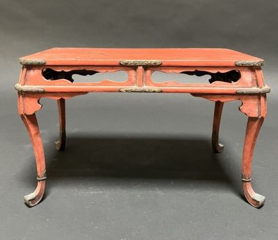 an orange painted desk with two drawers and a drawer on top of it