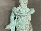 statue of a woman sitting on a rock with her arms wrapped around her neck