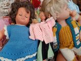 a lot of dolls that are sitting on top of each other