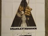 movie poster of a man holding a pair of scissors in front of a poster of a man holding a pair of scissors in front of a poster of a wall