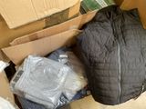 a pile of clothes in a box with a jacket on it