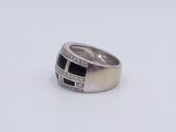 an image of a ring with black and white stones
