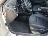 the interior of a white car with black leather seats and a steering wheel