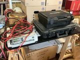 a stack of electronics sitting on top of a table in a room
