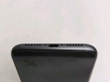 a close up view of the back of a black iphone