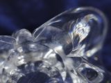 close up of a clear glass object with a blue background