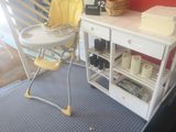 a baby high chair and a table in a room