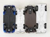 three toy cars sitting side by side on a white surface