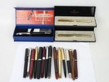a lot of pens and a pen case on the table
