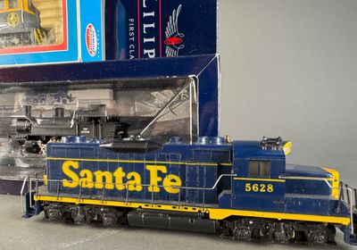 a toy train that is sitting in front of a box