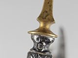 an image of a silver and gold knife on a white surface