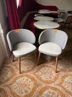two chairs and a table in the corner of a room