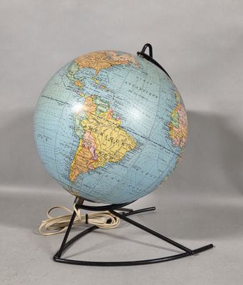 an image of a blue and yellow globe on a black stand