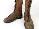 an old pair of brown leather boots with laces on them