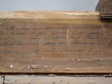 a piece of wood that has writing on it