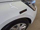 a close up of a white car with a sticker on it ' s hood