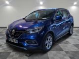 a blue car is parked on a checkered floor in a garage