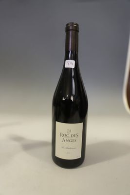 a bottle of wine sitting next to a glass of wine