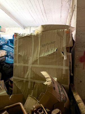 a pile of boxes and other items in a room