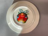 a white plate with a christmas ornament on it