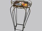 a small table with a glass top and metal legs