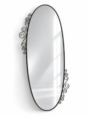 a black oval mirror hanging on the wall