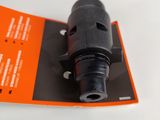 a black and orange label on a black and orange device