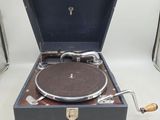 an old record player sitting in a suitcase on a table