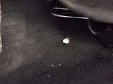 a small white object on the floor of a car