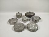 several silver metal objects are sitting on a white surface