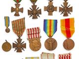 an assortment of medals and medals are displayed on a white surface