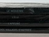 a stack of black plastic bags sitting on top of a table