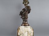 a statue of a woman holding a baby on top of a marble pedestal