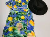 a picture of a dress and a hat on a table