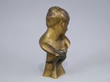 bronze statue of a boy holding a bird in his hand