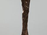 bronze statue of a woman with a hat on her head