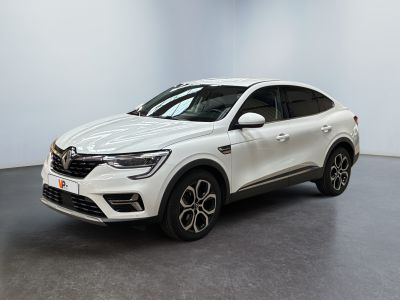 un SUV blanc garé dans une pièce au sol noir