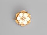 an 18k gold and diamond flower broochle