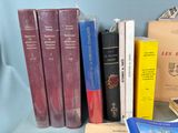 several books are sitting on a table next to each other