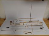 a lot of gold necklaces and other jewelry on a table
