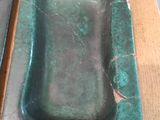 two green trays sitting on a table next to each other