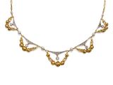 a gold and silver necklace with pearls on a white background