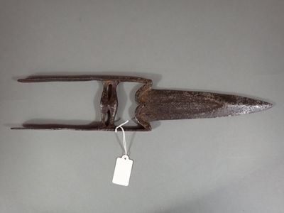 a small metal object with a tag attached to it
