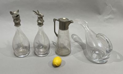three glass vases and a lemon on a table