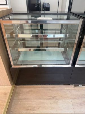 a glass display case in the middle of the floor