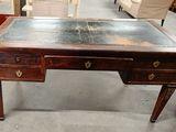 a wooden desk with two drawers and a metal top