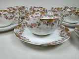 six cups and saucers sitting on a white table