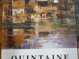 affiche représentant une peinture d'un village posée sur une table en bois