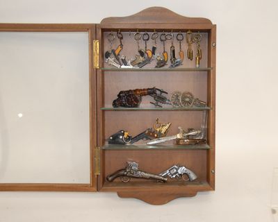 a wooden cabinet with a mirror and many pairs of scissors on it